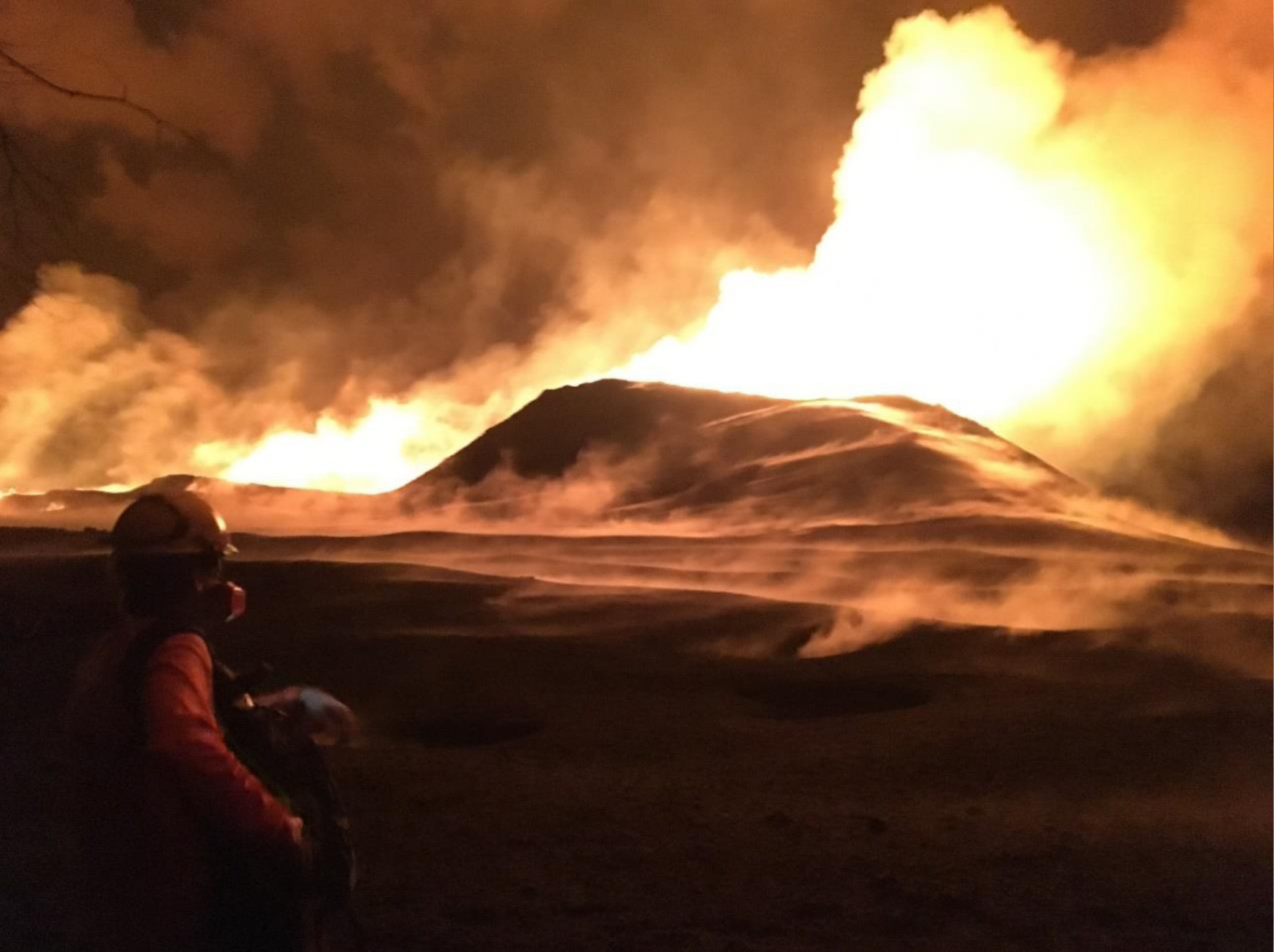 Man watching erupting volcano